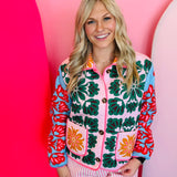 Cropped quilted floral jacket with collar, button front, and colorful pink, green, red, and blue pattern.