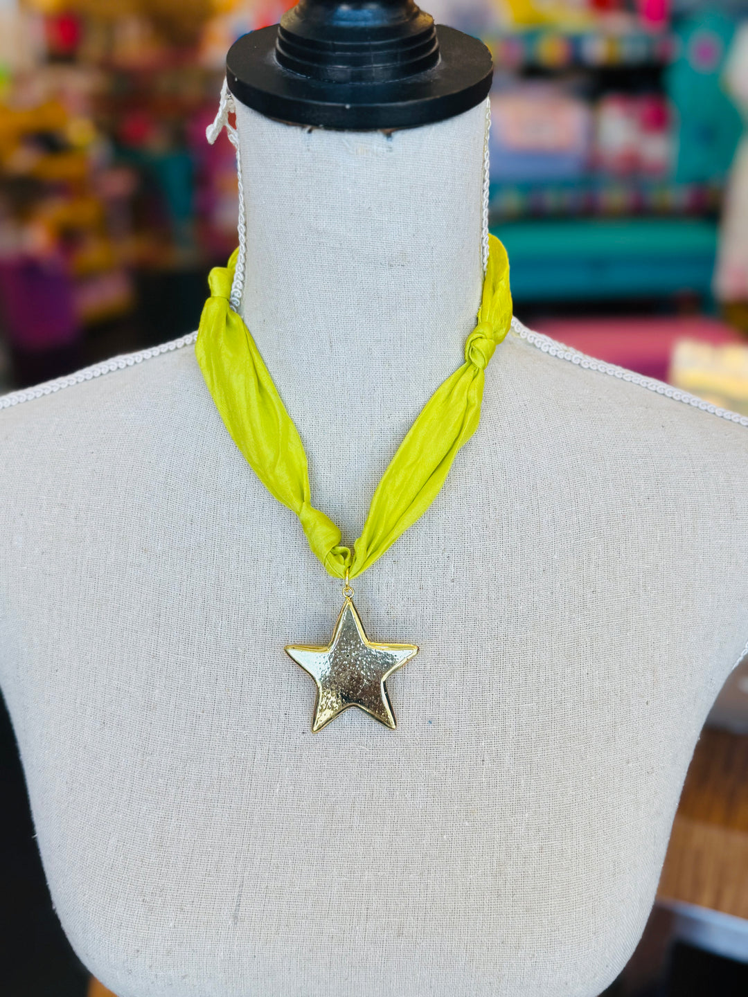 Lime green scarf necklace with a gold star charm, displayed on a neutral background. Lightweight and playful, this accessory adds a pop of color and whimsical shine to any outfit.