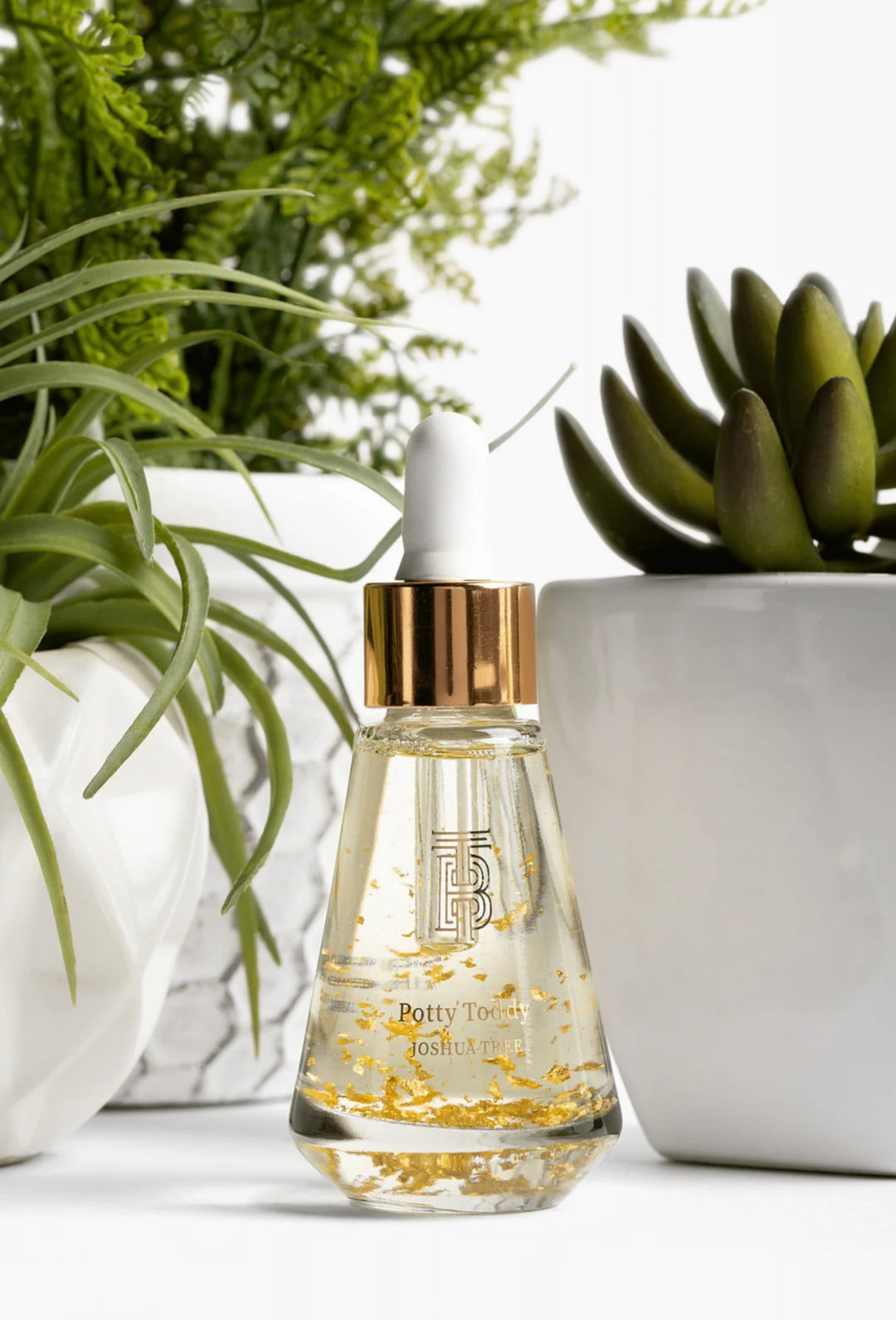 Thomas Blonde - small, elegant bottle of pre-toilet drops with visible 24-karat gold flakes floating inside.