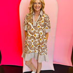 Brown floral mini dress with striped trim, half sleeves, collar, side pockets, and relaxed fit.