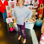 Eggplant colored stretchy leggings with destroyed front cutouts.