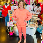 Coral colored crossover waistband leggings with sleek design 