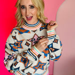 Cream Southwestern knit pullover with geometric star pattern, mock neckline, and ribbed trim.