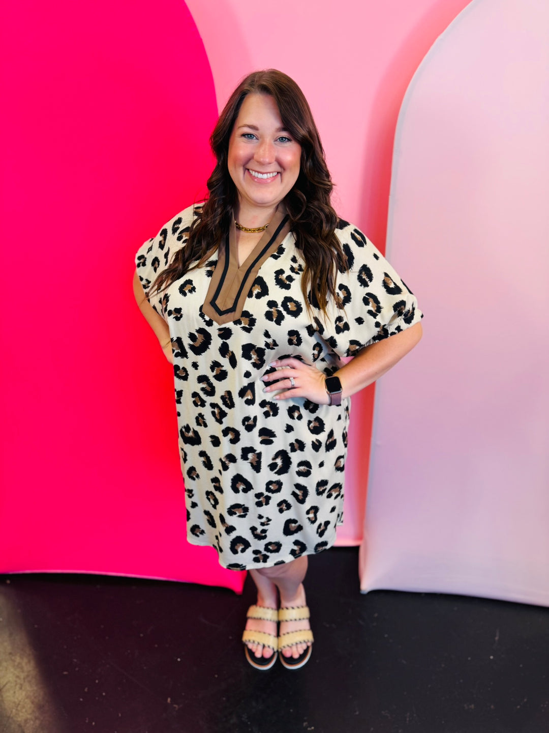 Leopard mini dress with dolman sleeves, pockets,and taupe and black v-neckline.