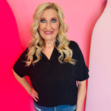 Black collared V-neck airflow top with short sleeves and a smooth, lightweight drape.