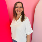 White collared V-neck airflow top with short sleeves and a smooth, breathable drape.