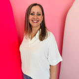 White collared V-neck airflow top with short sleeves and a smooth, breathable drape.