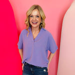 Lavender collared V-neck airflow top with short sleeves and a soft, lightweight drape.
