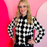 Black-and-white diamond sherpa jacket with corduroy collar, snap buttons, and oversized front pockets.