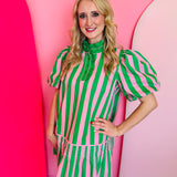 Pink and green striped poplin mini dress with ruffled neckline, bubble sleeves, and partial button placket.