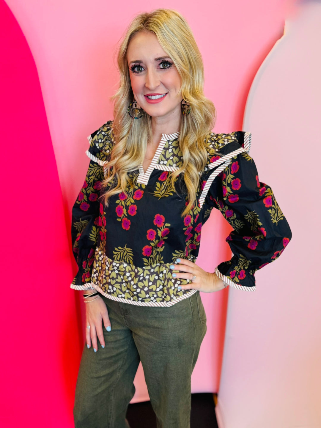 Black multi-print puff sleeve top with red and gold florals, ruffle shoulders.