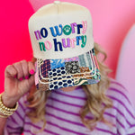 Neutral trucker hat with colorful no worry no hurry embroidery and vibrant patchwork printed bill.