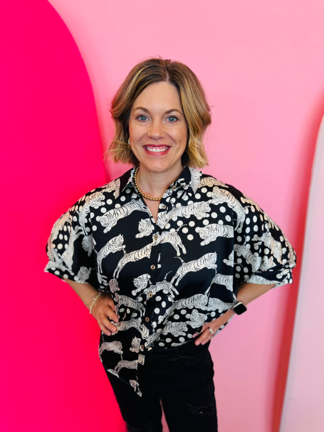 A black and white tiger mix polka dot printed button-down shirt with half sleeves.