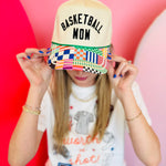 Neutral Basketball Mom trucker hat with black embroidery and colorful patchwork curved bill.