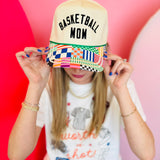 Neutral Basketball Mom trucker hat with black embroidery and colorful patchwork curved bill.