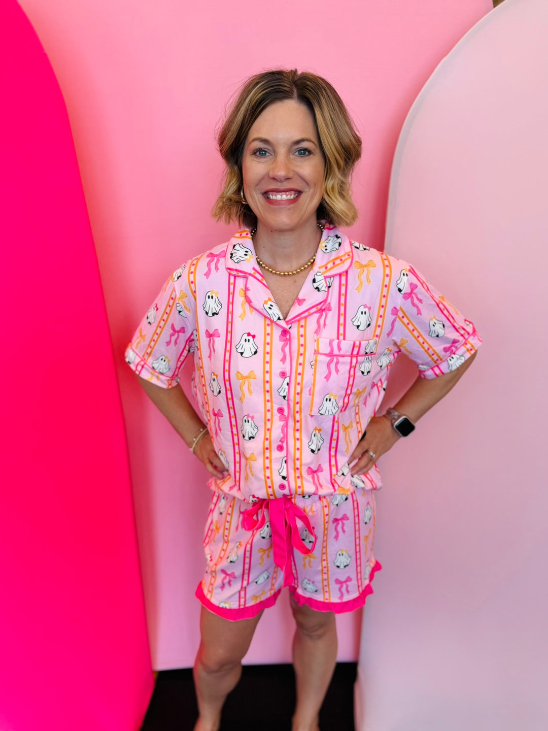 a pink pajama set with a ghost print top and ruffle shorts.