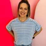 Cornflower blue ribbed striped top with exposed seams, cuffed sleeves, and high-low hem.