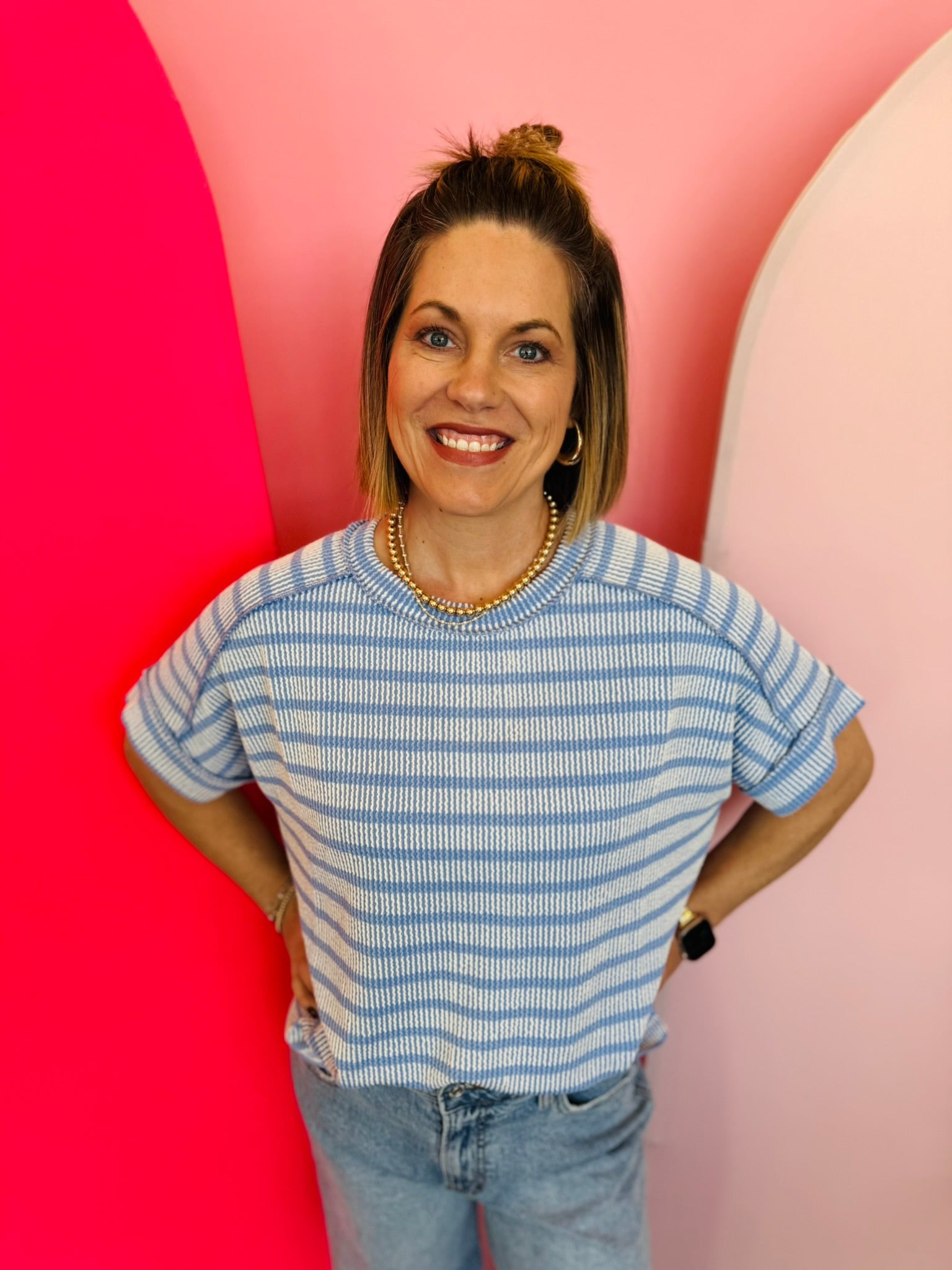 Cornflower blue ribbed striped top with exposed seams, cuffed sleeves, and high-low hem.