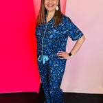Floral pajama set with button-up top, ruffle pants, and soft stretchy fabric in feminine, elegant design.