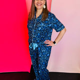 Floral pajama set with button-up top, ruffle pants, and soft stretchy fabric in feminine, elegant design.