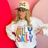 White sweatshirt with colorful “Literally Born to Dilly Dally” mixed-pattern lettering.