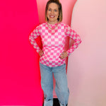 Pink checkered sheer mesh top with mock neckline and lettuce hems for trendy layered styling.
