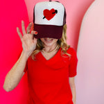 Mavis heart and arrow yarn embroidered maroon and white mesh trucker cap.