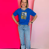 Royal blue tee with sparkling sequin cowboy boots patch and bold Western-inspired style.