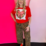 Red tee with leopard heart patch, pink bow, and sparkling bling accents on soft cotton.