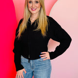 Black ribbed collared zip-up sweater with two-way zipper and soft textured knit.