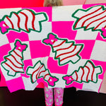 Pink checkered blanket with Christmas treats and pink bow design.