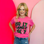 Bright pink holiday tee with glitter lettering, candy cane stripes, and holly accents.