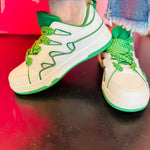 Green and white platform sneakers with zigzag laces.