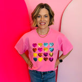 Bright pink top with multicolor sequin hearts and relaxed drop-shoulder fit.