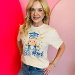 Cream tee with blue rhinestone nutcracker, rhinestone snowflakes, "Son Of A Nutcracker" lettering.