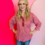 Burgundy striped top with contrast collar, pearl button, and 3/4 sleeves.