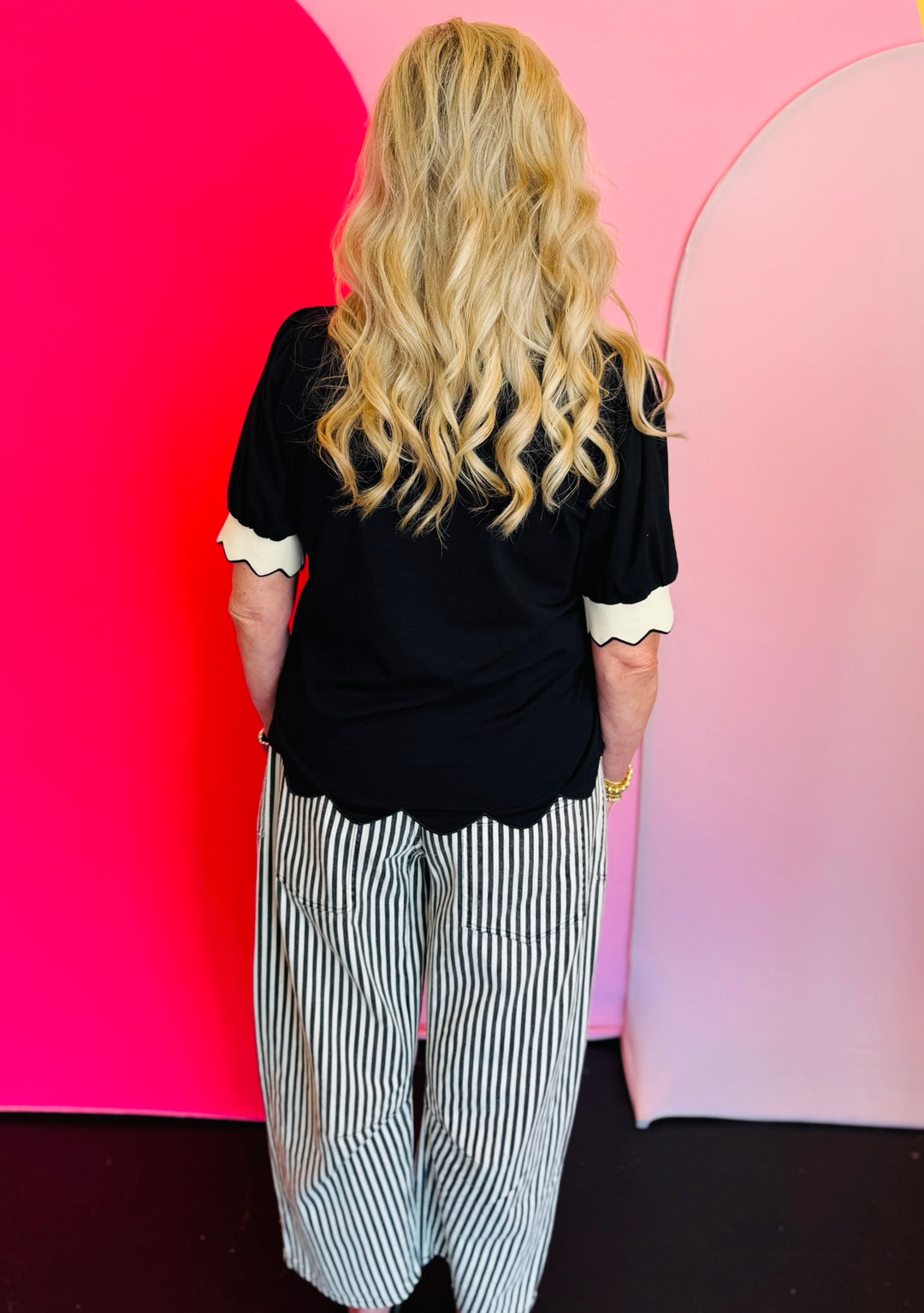 Black twill striped barrel-leg pants with subtle vertical stripes, featuring a natural rope twine belt threaded through eyelet loops; styled for a flattering, modern fit with a breathable 100% cotton fabric.
