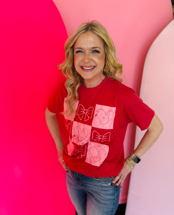 Red tee with pink and red checkered pattern, accented with bows and hearts.