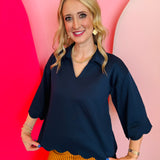Navy scallop top with V-neck, collared detail, and scalloped trim.