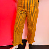 Tangerine and navy striped ruffled hem pants with high-rise waist and straight-leg silhouette.