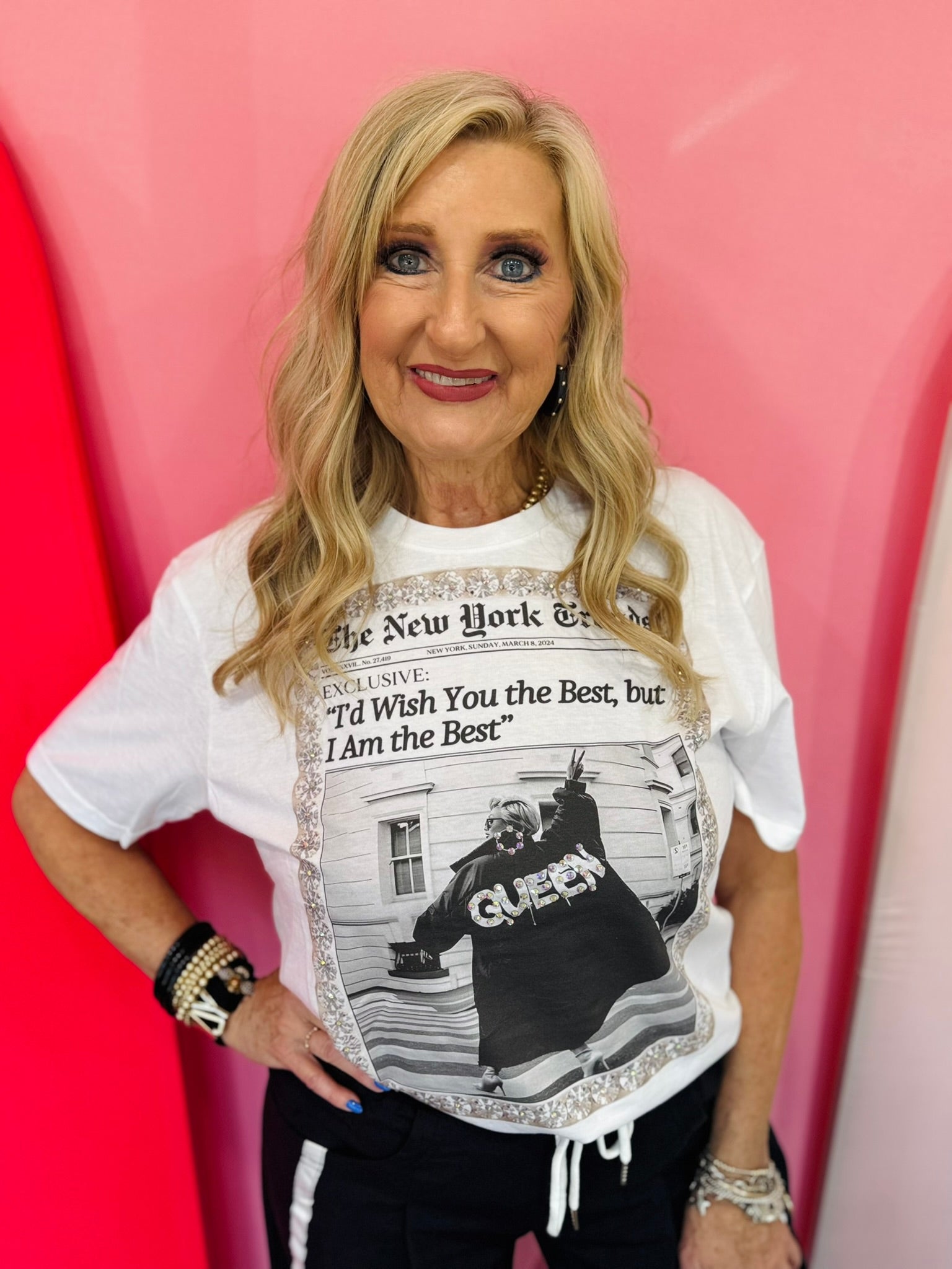 Ivory graphic tee with vintage newspaper design, rhinestones, and crystal-inspired border.
