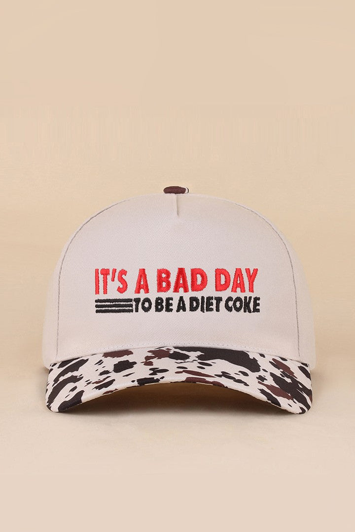 Two-tone snapback hat with It's A Bad Day To Be A Diet Coke embroidered saying.