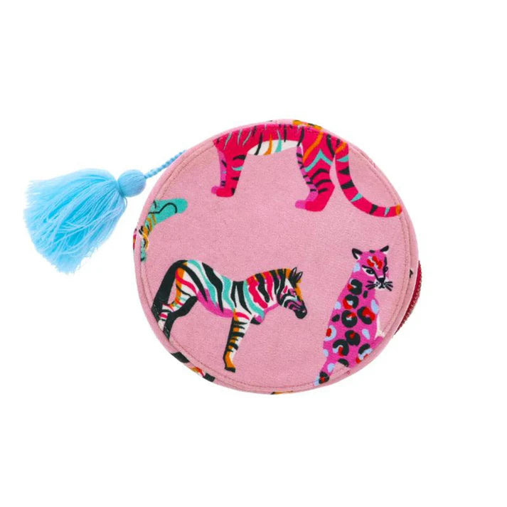 A round, zippered jewelry case made of pink viscose velvet. The case features a colorful pattern of various animal prints, including zebra and leopard. A bright blue tassel is attached to the zipper.
