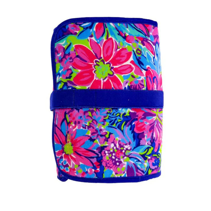A hanging toiletry bag made of viscose velvet with a bold, colorful floral print. 