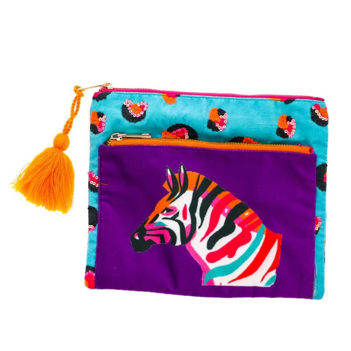 A set of two zippered pouches made of viscose velvet. The larger pouch has a turquoise leopard print with an orange tassel zipper pull. The smaller pouch is purple with a multi-color zebra graphic and a tassel zipper pull.