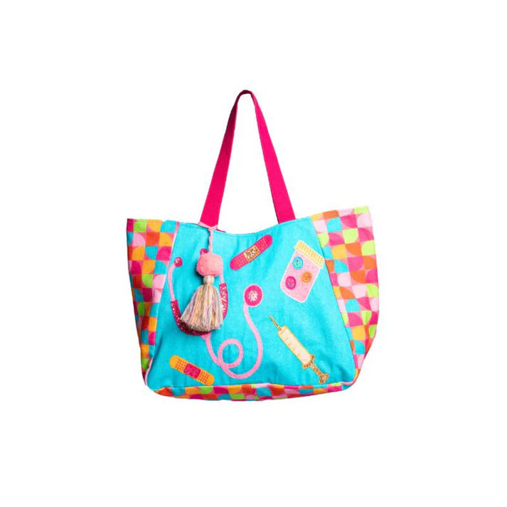 A large tote bag with a turquoise background and a repeating pattern of medical-themed graphics. The bag has colorful geometric-patterned sides, sturdy pink handles, and a decorative tassel charm.