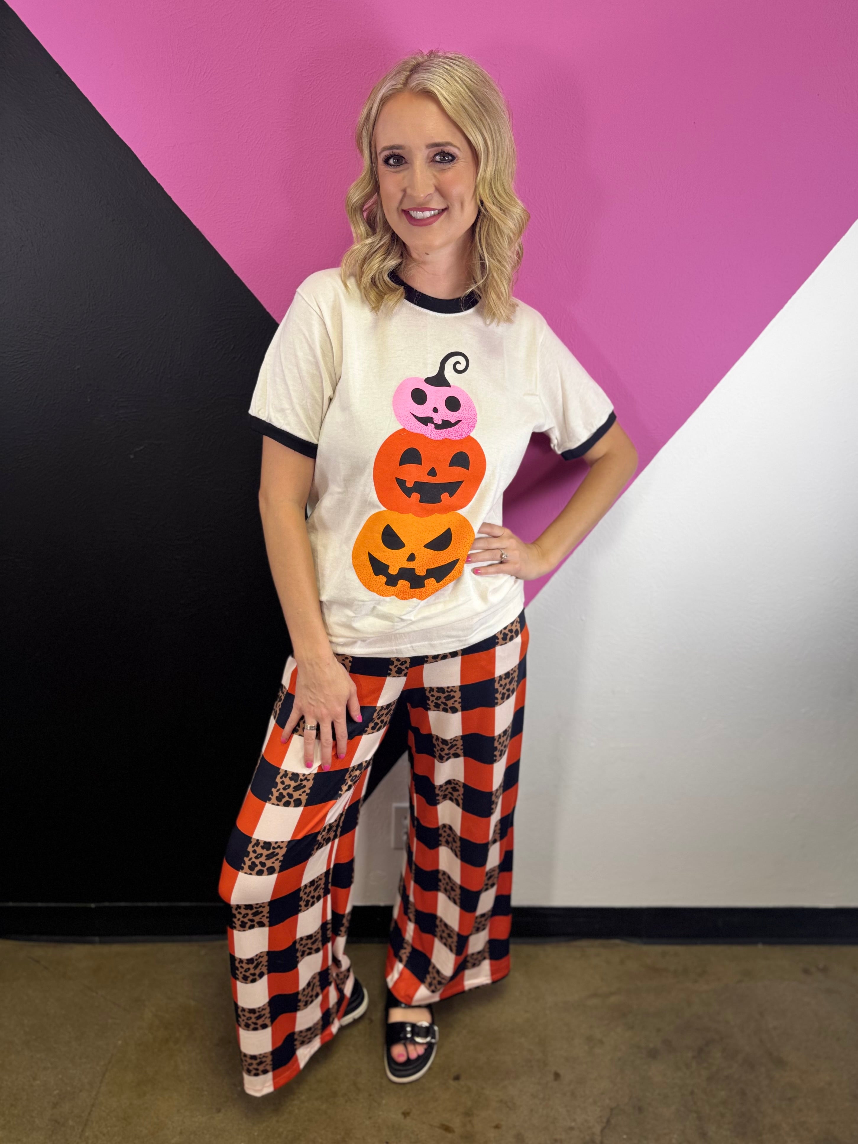 White Halloween tee with stacked pink, red-orange, and orange jack-o’-lanterns.