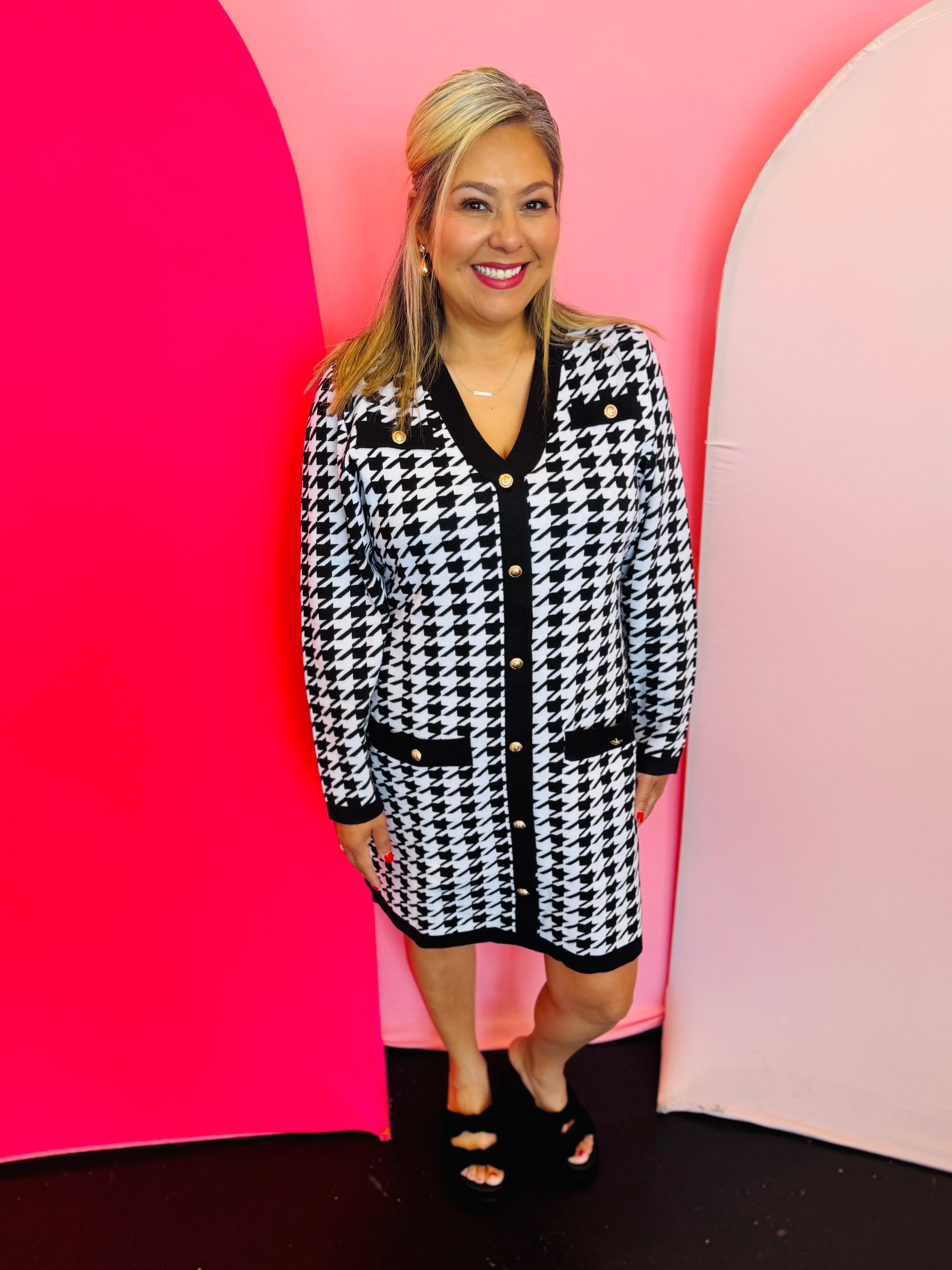 Jess Lea Houndstooth sweater dress with gold buttons, v-neckline, black trim, and front pockets.