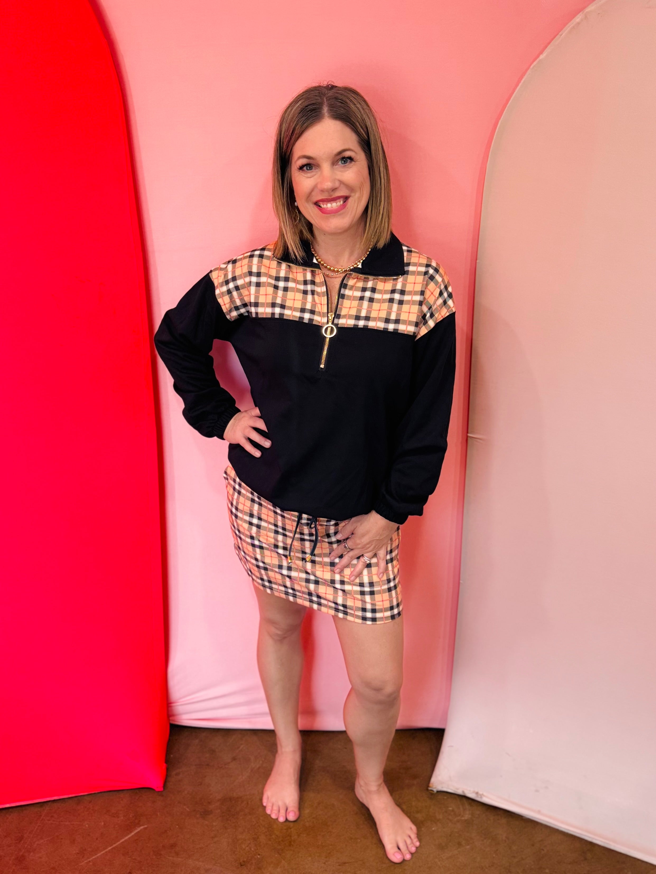Plaid color-block quarter-zip pullover with gold hardware and cozy collar.