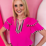 Neon pink flutter sleeve blouse with colorful striped neckline and sleeve trim.
